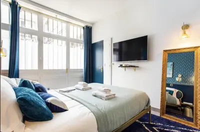 Un ou plusieurs lits dans un hébergement de l'établissement Charming 2BR # Grands Boulevards