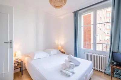 Un ou plusieurs lits dans un hébergement de l'établissement Appartement - Roland-Garros & Parc des Princes