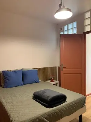 Un ou plusieurs lits dans un hébergement de l'établissement appartement RDC gauche