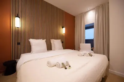 Un ou plusieurs lits dans un hébergement de l'établissement 2Cozy1BR#Exhibition Centre
