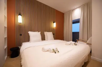 Un ou plusieurs lits dans un hébergement de l'établissement 2Cozy1BR#Exhibition Centre