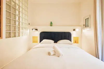 Un ou plusieurs lits dans un hébergement de l'établissement Grand studio pour 4p Paris 14