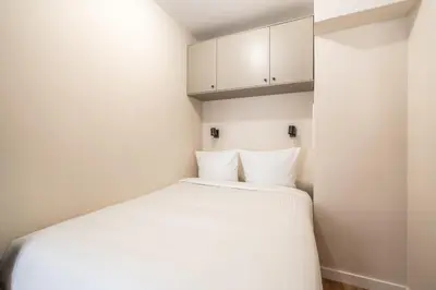 Un ou plusieurs lits dans un hébergement de l'établissement Studio Cozy Design - Batignolles