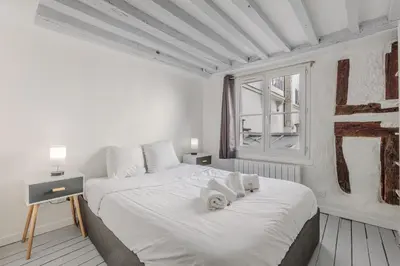 Un ou plusieurs lits dans un hébergement de l'établissement Apartment Cosy 3P Quartier République