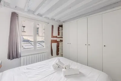 Un ou plusieurs lits dans un hébergement de l'établissement Apartment Cosy 3P Quartier République