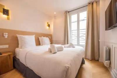 Un ou plusieurs lits dans un hébergement de l'établissement Lovely Flat near Rue Crémieux & Bastille