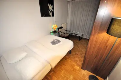 Un ou plusieurs lits dans un hébergement de l'établissement Spacieux appartement pour 6, à Parc de la Villette