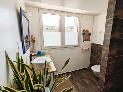 Télévision ou salle de divertissement dans l'établissement Le Penthouse de Boulogne entre la Seine et le Jardin
