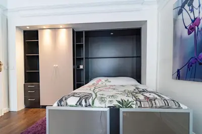 Un ou plusieurs lits dans un hébergement de l'établissement Appartement Champs Elysées