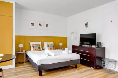 Un ou plusieurs lits dans un hébergement de l'établissement Eiffel residence Augustin