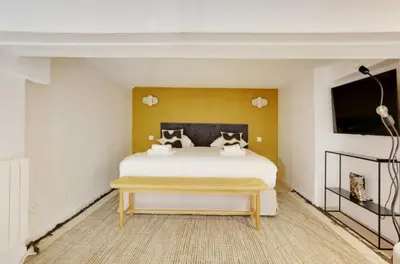 Un ou plusieurs lits dans un hébergement de l'établissement Duplex Cosy Canal Saint Martin