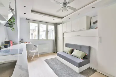 Un ou plusieurs lits dans un hébergement de l'établissement Chic Studio near Arc de Triomphe