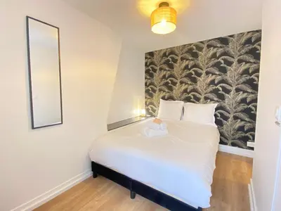 Un ou plusieurs lits dans un hébergement de l'établissement GuestReady - Cozy nest in Salpêtrière