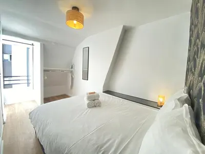 Un ou plusieurs lits dans un hébergement de l'établissement GuestReady - Cozy nest in Salpêtrière