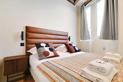 Un ou plusieurs lits dans un hébergement de l'établissement Les Halles - Grands Boulevards Cozy 1BR - 4P