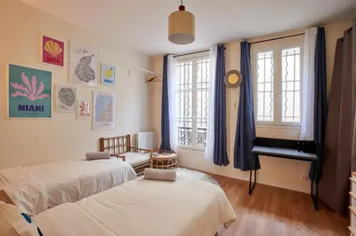 Un ou plusieurs lits dans un hébergement de l'établissement Lovely flat Marais - Orange