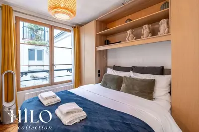 Un ou plusieurs lits dans un hébergement de l'établissement Suite Paris Stendhal by HILO Collection - 6people - 70m2