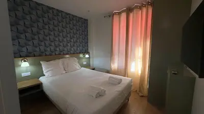 Un ou plusieurs lits dans un hébergement de l'établissement Alma Hotel