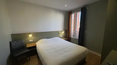 Un ou plusieurs lits dans un hébergement de l'établissement Alma Hotel