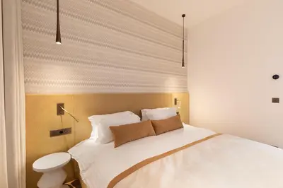 Un ou plusieurs lits dans un hébergement de l'établissement Oniri - Serviced Apartments in Louvre - Rue de Richelieu