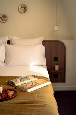 Un ou plusieurs lits dans un hébergement de l'établissement LALA Hôtel