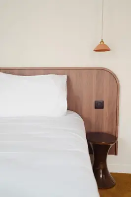 Un ou plusieurs lits dans un hébergement de l'établissement LALA Hôtel