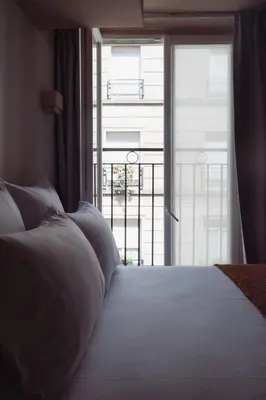 Un ou plusieurs lits dans un hébergement de l'établissement LALA Hôtel