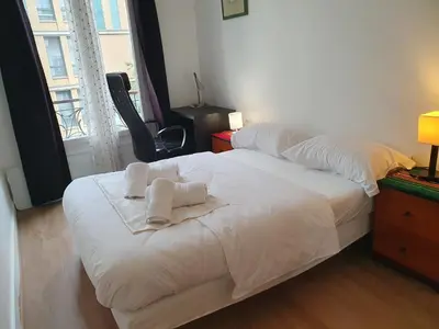 Un ou plusieurs lits dans un hébergement de l'établissement Appartement au cœur de Paris