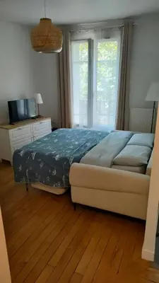 Un ou plusieurs lits dans un hébergement de l'établissement Appartement - 4 voyageurs - accès direct Paris