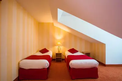 Un ou plusieurs lits dans un hébergement de l'établissement Hotel Delambre