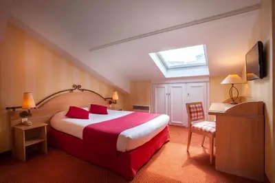 Un ou plusieurs lits dans un hébergement de l'établissement Hotel Delambre