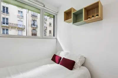 Un ou plusieurs lits dans un hébergement de l'établissement Studio bien équipé à proximité du Parc des Princes