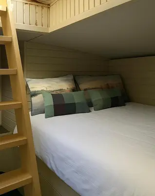 Un ou plusieurs lits dans un hébergement de l'établissement La cabine du capitaine