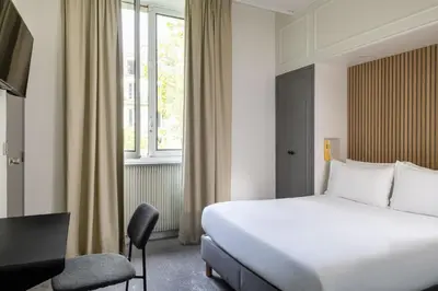 Un ou plusieurs lits dans un hébergement de l'établissement Hôtel Korner Châtelet