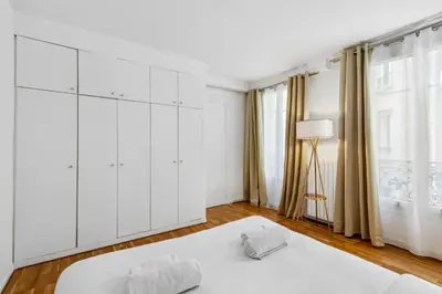 Un ou plusieurs lits dans un hébergement de l'établissement Amazing Apt 3BDR near The Eiffel Tower