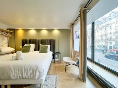 Un ou plusieurs lits dans un hébergement de l'établissement Urban Flat 194 - Cosy 3 Bedroom Opera Grands Boulevards