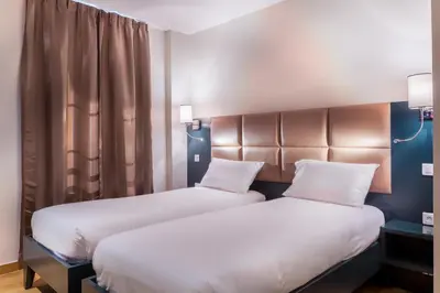 Un ou plusieurs lits dans un hébergement de l'établissement Hotel Jenner