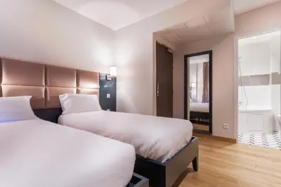 Un ou plusieurs lits dans un hébergement de l'établissement Hotel Jenner