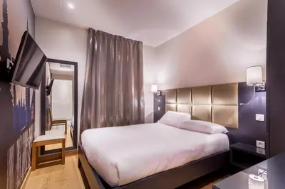 Un ou plusieurs lits dans un hébergement de l'établissement Hotel Jenner