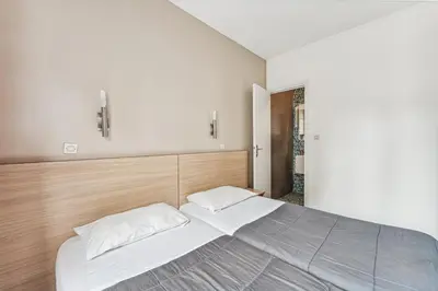 Un ou plusieurs lits dans un hébergement de l'établissement Hotel Tolbiac