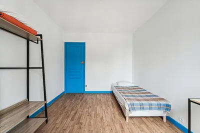 Un ou plusieurs lits dans un hébergement de l'établissement Hotel Tolbiac