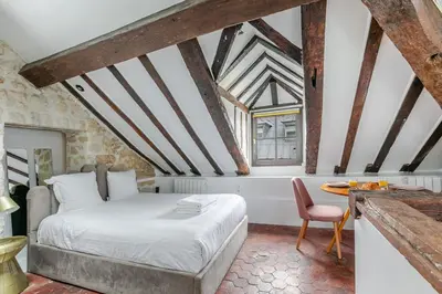 Un ou plusieurs lits dans un hébergement de l'établissement Studio sous les poutres à Paris