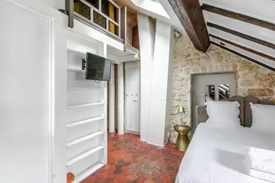 Un ou plusieurs lits dans un hébergement de l'établissement Studio sous les poutres à Paris