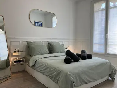 Un ou plusieurs lits dans un hébergement de l'établissement Charmant appartement décoré proche du parc des expositions