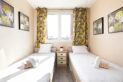 Un ou plusieurs lits dans un hébergement de l'établissement Gorgeous apartment Near Paris - 5P