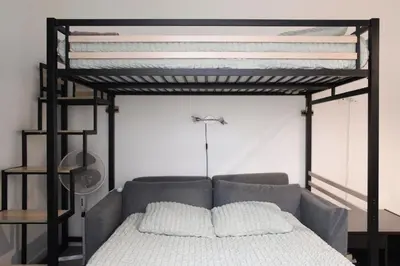 Un ou plusieurs lits dans un hébergement de l'établissement Studio cosy À deux pas de Montmartre