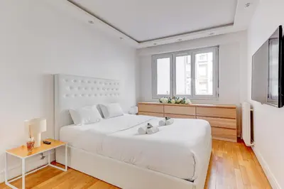 Un ou plusieurs lits dans un hébergement de l'établissement Appartement chic 82m2 6 pers Paris 16E