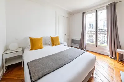 Un ou plusieurs lits dans un hébergement de l'établissement Appartements Bergère