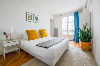 Un ou plusieurs lits dans un hébergement de l'établissement Appartements Bergère