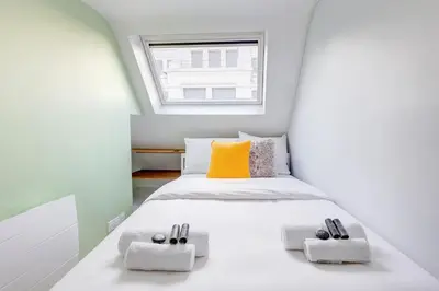 Un ou plusieurs lits dans un hébergement de l'établissement Stylish Nest - Heart of Paris